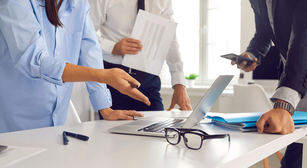 People in an office engaged in a boardroom discussion.