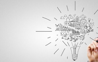 Person drawing a business strategy in the form of a lightbulb