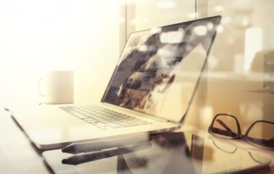 laptop, tablet, stylus and glasses sitting on top of a desk