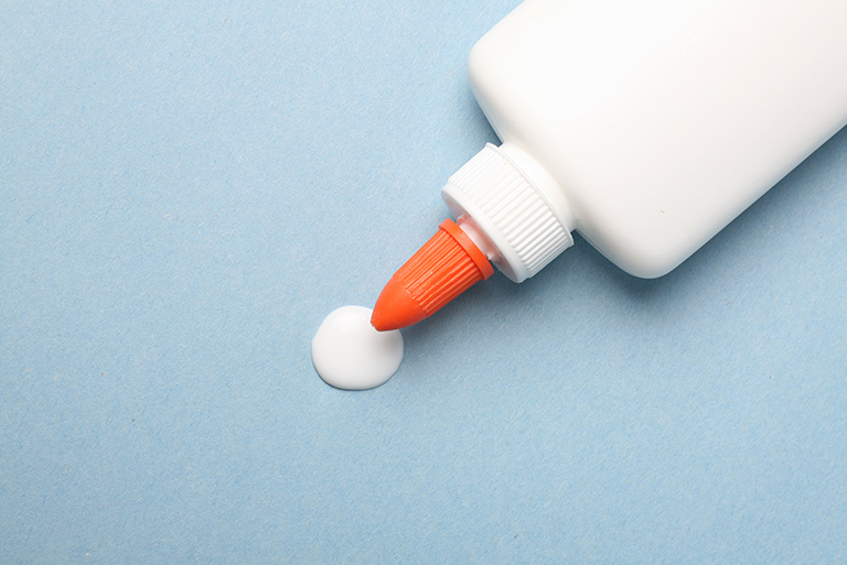 a child's glue bottle laying on it's side