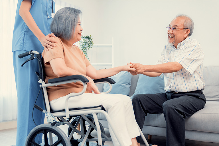 two elderly people being assisted by a nurse