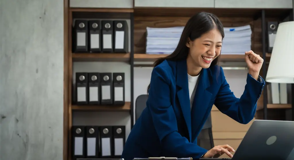 buisness woman celebrating in an office setting