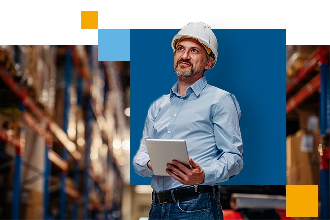 man in a hard hat with an ipad in a distribution center