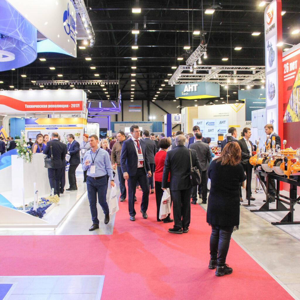 Convention show floor with people walking around and observing trade show booths.