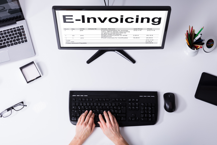 Businessperson Preparing E-invoicing Bill On Computer